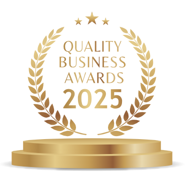 Gold and white award emblem for the 2025 Quality Business Awards, featuring a laurel wreath and a trophy pedestal.